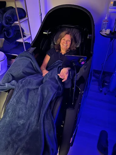 A relaxed Prime IV guest reclining in a zero-gravity recovery chair during treatment